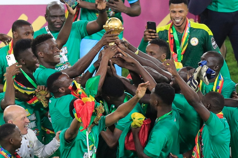 Senegal national team celebrate the AFCON trophy at the Olembe Stadium in Cameroon after defeating Egypt in the final by 4-2 on February 6, 2022