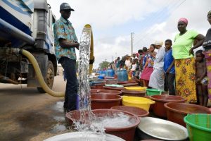 people queuing to fetch water from a tanker