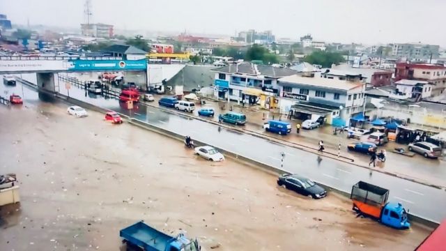 cars moving through flooded roads in Accra