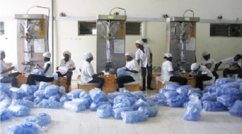 Workers packaging sachet water during production