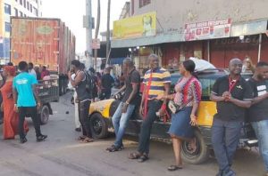 Adum traders lock their shops and stand outside to protest against high taxes