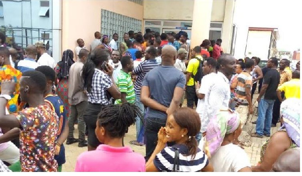 Customers form long queues at ECG office