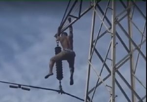 Kofi Kakra hangs on the high tension pole